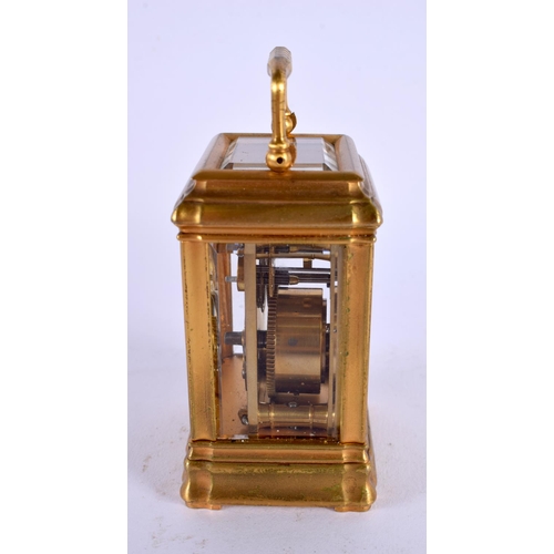 708 - A MINIATURE ANTIQUE FRENCH BRASS CARRIAGE CLOCK. 9.5 cm high inc handle.