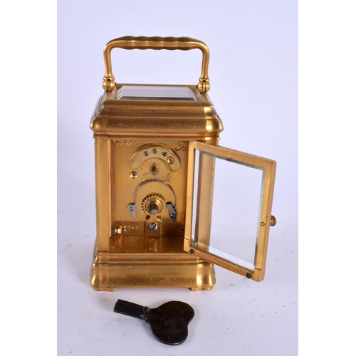 708 - A MINIATURE ANTIQUE FRENCH BRASS CARRIAGE CLOCK. 9.5 cm high inc handle.