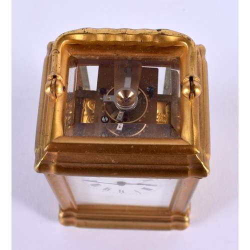 708 - A MINIATURE ANTIQUE FRENCH BRASS CARRIAGE CLOCK. 9.5 cm high inc handle.