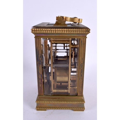 710 - AN ANTIQUE REPEATING BRASS CARRIAGE CLOCK. 18 cm high inc handle.