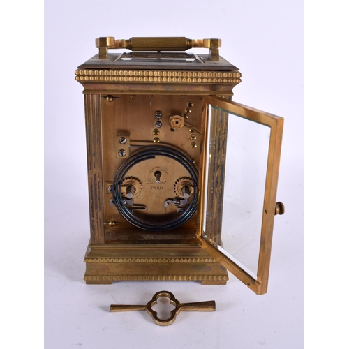 710 - AN ANTIQUE REPEATING BRASS CARRIAGE CLOCK. 18 cm high inc handle.