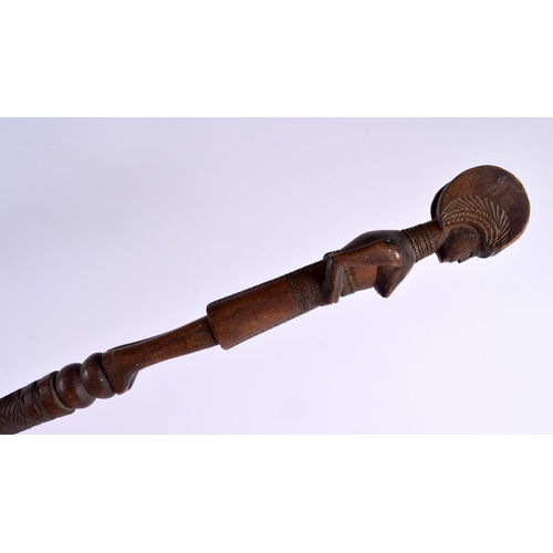 742 - AN EARLY 20TH CENTURY AFRICAN TRIBAL CARVED WOOD FERTILITY STAFF with bead work eyes. 95 cm long.