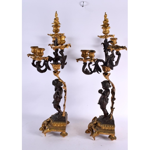 774 - A LARGE PAIR OF 19TH CENTURY FRENCH BRONZE CANDLEABRA formed as putti. 56 cm x 22 cm.