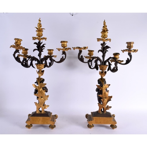 774 - A LARGE PAIR OF 19TH CENTURY FRENCH BRONZE CANDLEABRA formed as putti. 56 cm x 22 cm.