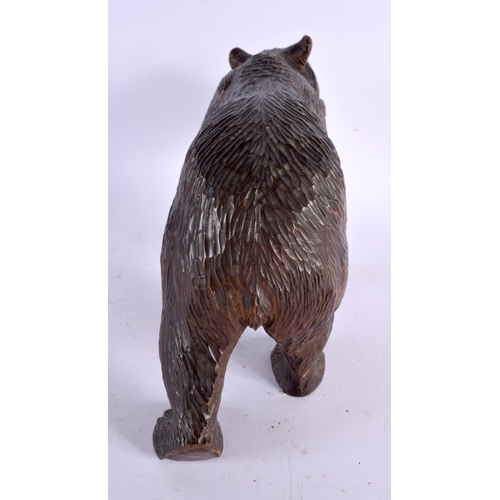 776 - A 19TH CENTURY BAVARIAN BLACK FOREST CARVED WOOD FIGURE OF A BEAR modelled roaming. 24 cm x 15 cm.