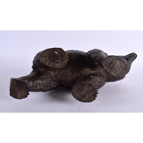 776 - A 19TH CENTURY BAVARIAN BLACK FOREST CARVED WOOD FIGURE OF A BEAR modelled roaming. 24 cm x 15 cm.