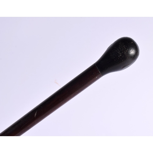 800 - AN 18TH/19TH CENTURY CONTINENTAL CARVED SWAGGER STICK formed as with a blackamoor head. 75 cm long.