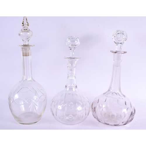 97 - THREE CUT GLASS DECANTERS AND STOPPERS. Largest 40 cm high. (3)