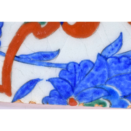 475 - A LARGE TURKISH MIDDLE EASTERN IZNIK TILE painted with flowers. 25 cm square.