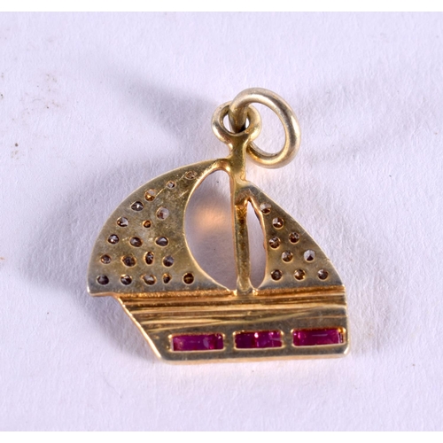 1028 - A DIAMOND AND RUBY BOAT CHARM. 1.3 grams. 2 cm x 1.5 cm.