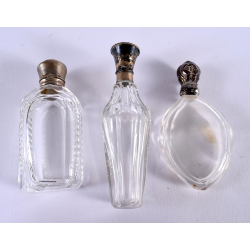 1048 - THREE ANTIQUE SILVER TOPPED SCENT BOTTLES. 229 grams. 11 cm x 3.25 cm. (3)