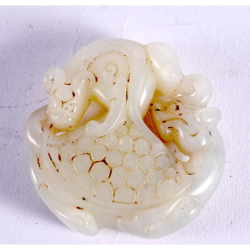 1139 - A CHINESE CARVED JADE ROUNDEL 20th Century. 5 cm wide.