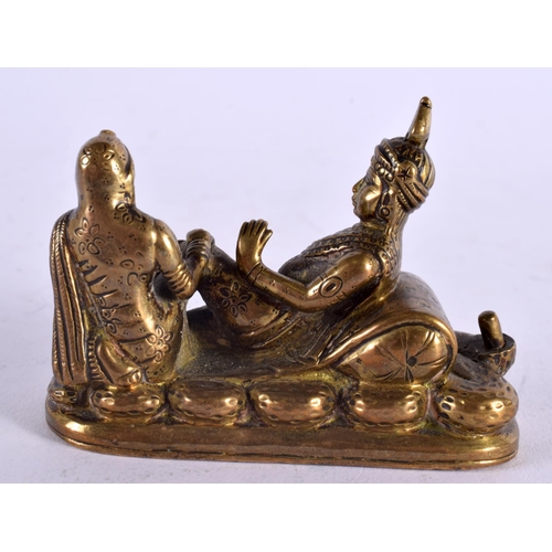 1145 - AN ANTIQUE INDIAN BRONZE FIGURAL GROUP depicting a female massaging a male. 8 cm x 5 cm.