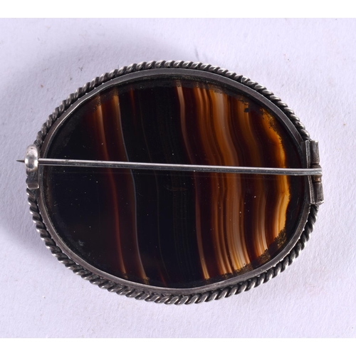 1179 - A LARGE ANTIQUE SILVER MOUNTED BANDED AGATE BROOCH. 21 grams. 5.5 cm x 4 cm.