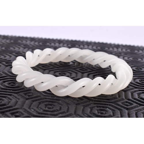 1194 - A CHINESE CARVED WHITE JADE RETICULATED BANGLE. 30 grams. 6.25 cm wide.