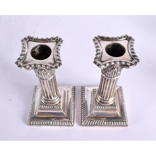 1195 - A PAIR OF EDWARDIAN SILVER CANDLESTICKS. Birminghan 1902. 942 grams overall. 15 cm x 7 cm.