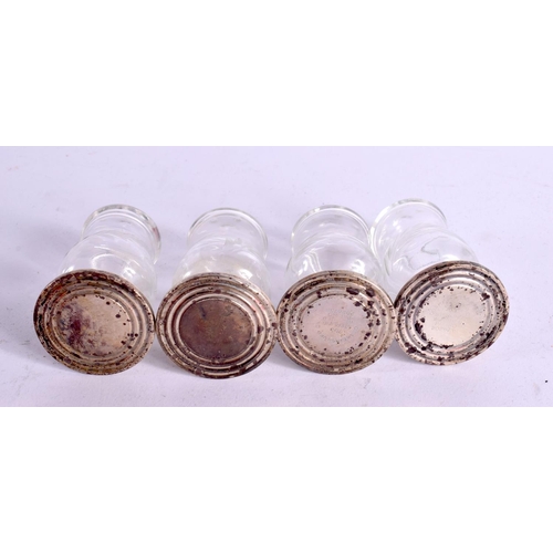 1222 - A SET OF FOUR SILVER AND GLASS CONDIMENTS. Silver 84 grams. 7 cm x 4.25 cm. (4)