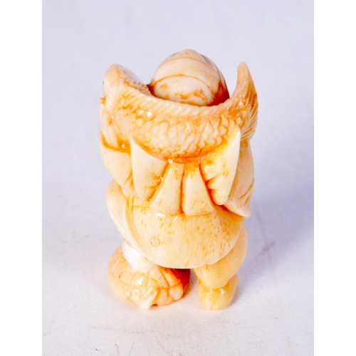 1385 - A JAPANESE CARVED BONE FISHERMAN NETSUKE. 32 grams. 5 cm x 2.75 cm.