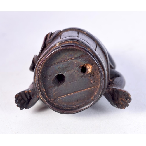 1404 - A CARVED WOOD NETSUKE IN THE FORM OF A MONKEY SITTING ON A BARREL. 5cm x 4cm