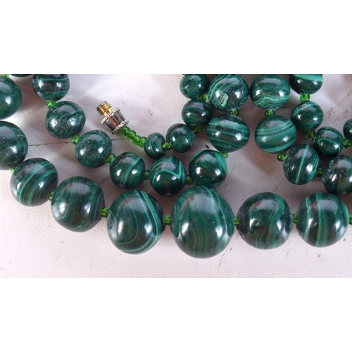 1412 - A STRING OF MALACHITE BEADS. Length 65cm, largest bead 19mm, weight 40g