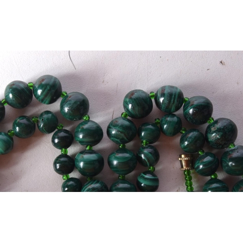 1412 - A STRING OF MALACHITE BEADS. Length 65cm, largest bead 19mm, weight 40g