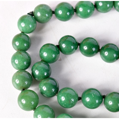 1425 - A STRING OF GREEN HARDSTONE BEADS. 84cm long, Beads 11.6mm, weight 154g