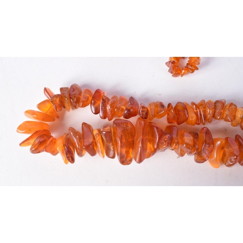 1442 - FOUR AMBER COLOURED BEAD NECKLACES. Longest 80cm (4)