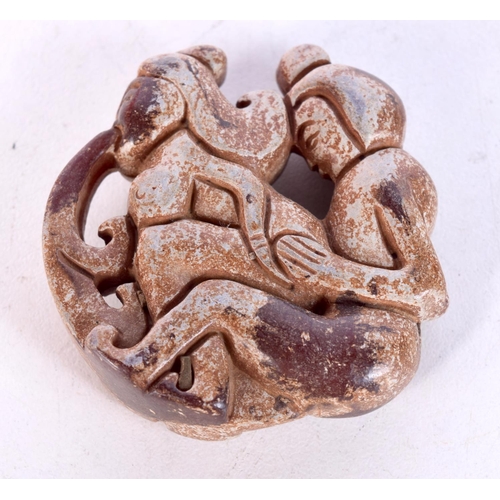 1451 - AN EROTIC JADE ROUNDEL. 5cm diameter