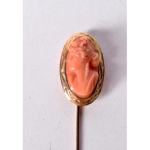 1461 - AN ANTIQUE GOLD AND CORAL STICK PIN CARVED WITH A CLASSICAL BUST. 7cm x 1.4cm, weight 4.2g