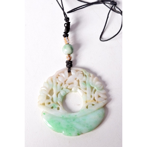 1464 - A TWO TONE GREEN JADE PENDANT. 5.1cm diameter