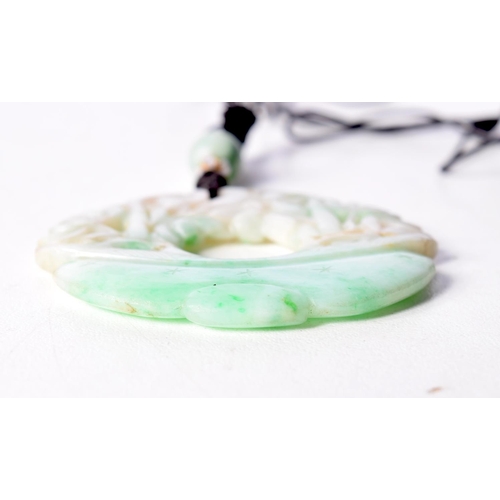 1464 - A TWO TONE GREEN JADE PENDANT. 5.1cm diameter