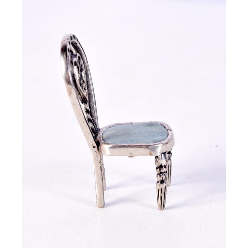 1514 - A SILVER CHAIR. 10.4 grams. 4.5 cm x 2.5 cm.