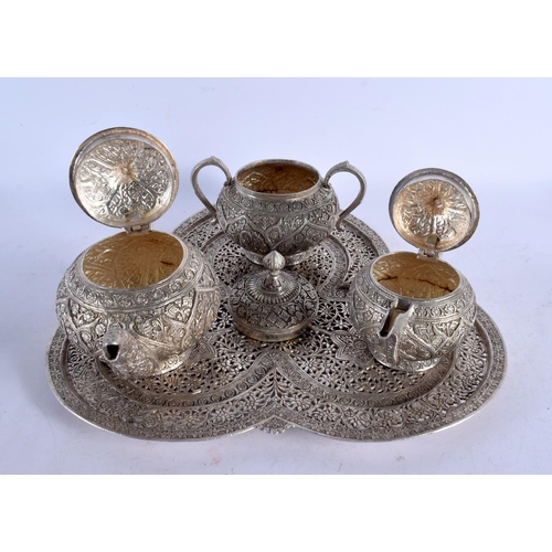 1555 - A 19TH CENTURY INDO PERSIAN SILVER TEASET WITH TRAY decorated with foliage. 2978 grams. Largest 32 c... 