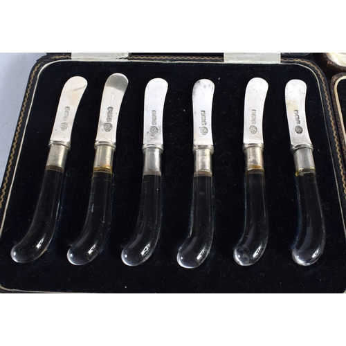 1646 - A CASED SET OF ART DECO PISTOL GRIP SILVER KNIVES together with a set of silver spoons. Sheffield 19... 