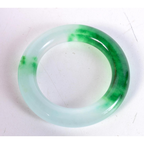 1715 - A CHINESE CARVED JADE BANGLE. 97 grams. 6 cm diameter.