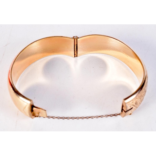 1744 - A 9CT GOLD PLATED BANGLE. 26.7 grams. 5.5 cm x 5.75 cm.