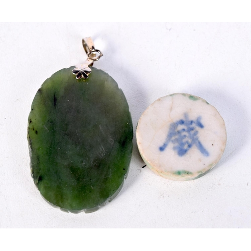 1823 - AN EARLY CHINESE POTTERY TOKEN together with a jade pendant. 15 grams. Largest 5 cm x 2.75 cm. (2)