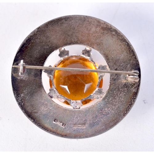 1832 - A SCOTTISH STYLE SILVER AND CITRINE BROOCH. 16 grams. Birmingham 1965. 4.5 cm diameter.