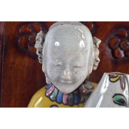 2053 - AN EARLY 19TH CENTURY CHINESE FAMILLE ROSE PORCELAIN FIGURE Jiaqing, modelled upon a hardwood stand.... 