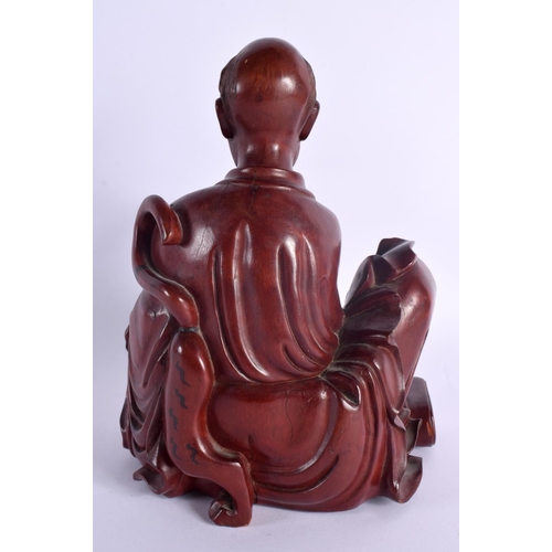 2075 - A LATE 19TH CENTURY CHINESE CARVED HARDWOOD FIGURE OF A MALE Qing, modelled beside a tiger. 22 cm x ... 