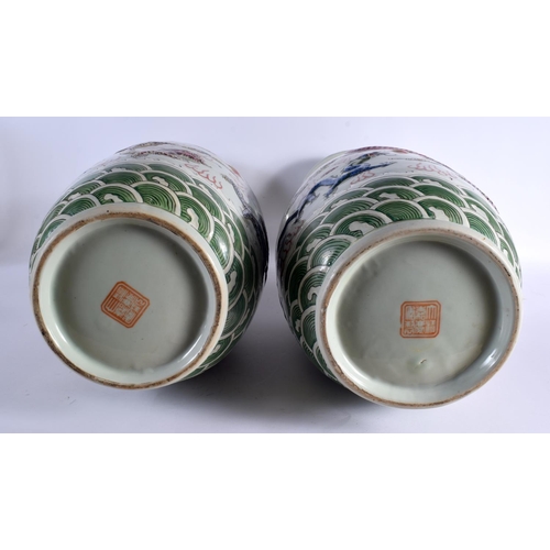 2121 - A LARGE PAIR OF CHINESE TWIN HANDLED FAMILLE ROSE VASES 20th Century, overlaid in relief with dragon... 