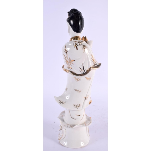 2134 - A LARGE CHINESE REPUBLICAN PERIOD PORCELAIN FIGURE OF AN IMMORTAL modelled holding a floral sceptre.... 