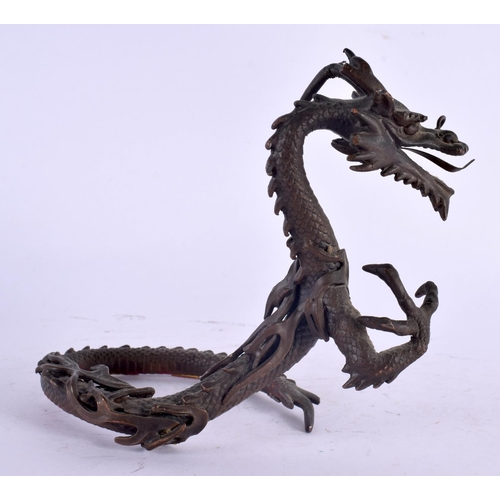 2135 - A 19TH CENTURY JAPANESE MEIJI PERIOD BRONZE OKIMONO modelled as a coiled dragon. 14 cm x 10 cm.