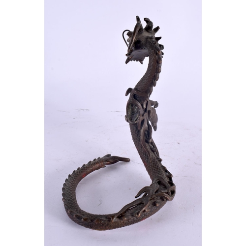 2135 - A 19TH CENTURY JAPANESE MEIJI PERIOD BRONZE OKIMONO modelled as a coiled dragon. 14 cm x 10 cm.