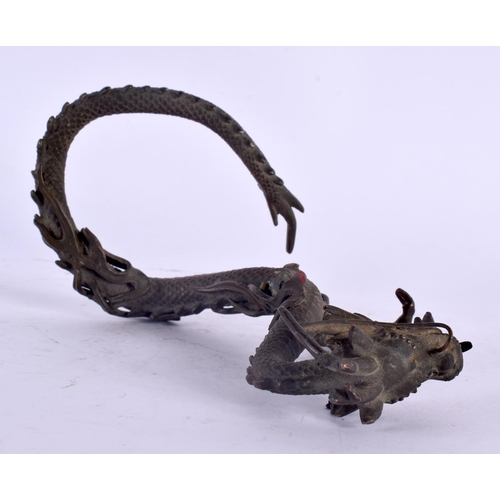 2135 - A 19TH CENTURY JAPANESE MEIJI PERIOD BRONZE OKIMONO modelled as a coiled dragon. 14 cm x 10 cm.