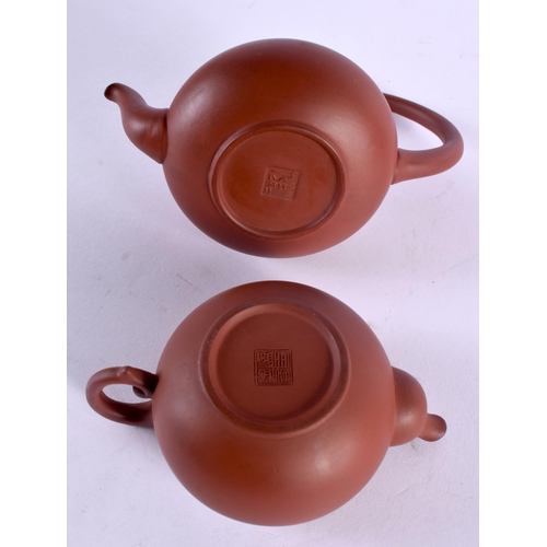 2142 - THREE CHINESE YIXING POTTERY TEAPOTS AND COVERS 20th Century. Largest 14 cm wide. (3)