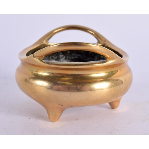 2200 - A MINIATURE 19TH CENTURY CHINESE TWIN HANDLED BRONZE CENSER of plain form. 140 grams. 7 cm wide, int... 