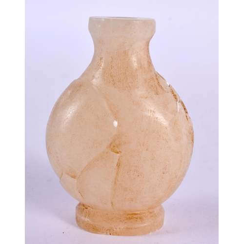 2239 - A CHINESE JADE VASE 20th Century, together with a jade toggle & archers ring. Largest 7 cm x 4.5 cm.... 