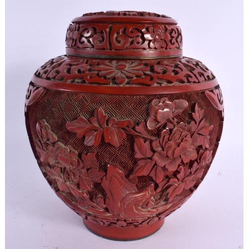 2288 - A 19TH CENTURY CHINESE CARVED CINNABAR LACQUER GINGER JAR AND COVER decorated with foliage. 15 cm x ... 