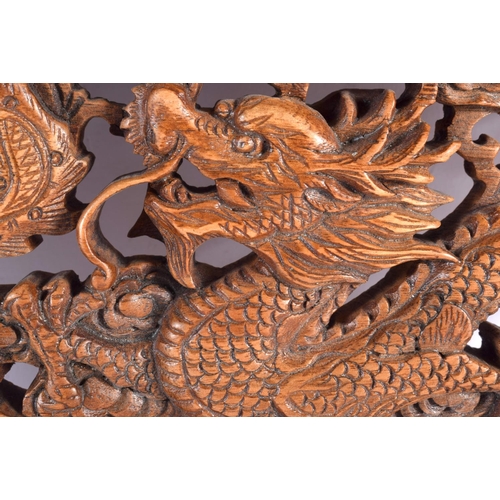 2296 - AN EARLY 20TH CENTURY CHINESE CARVED WOOD DRAGON AND PHOENIX PANEL Late Qing/Republic. 34 cm x 24 cm... 